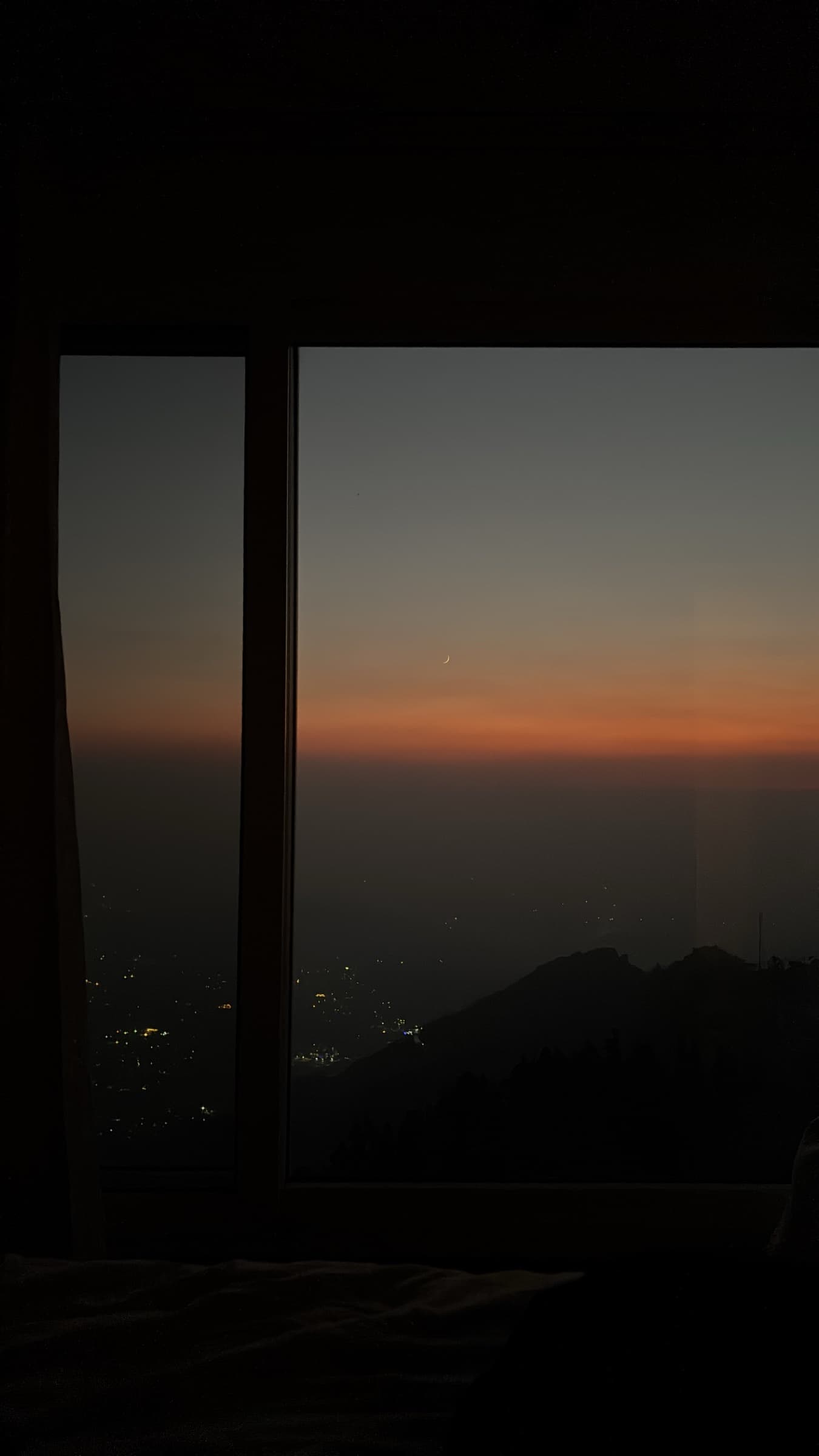 Dusk view through a window over the Mussoorie valley